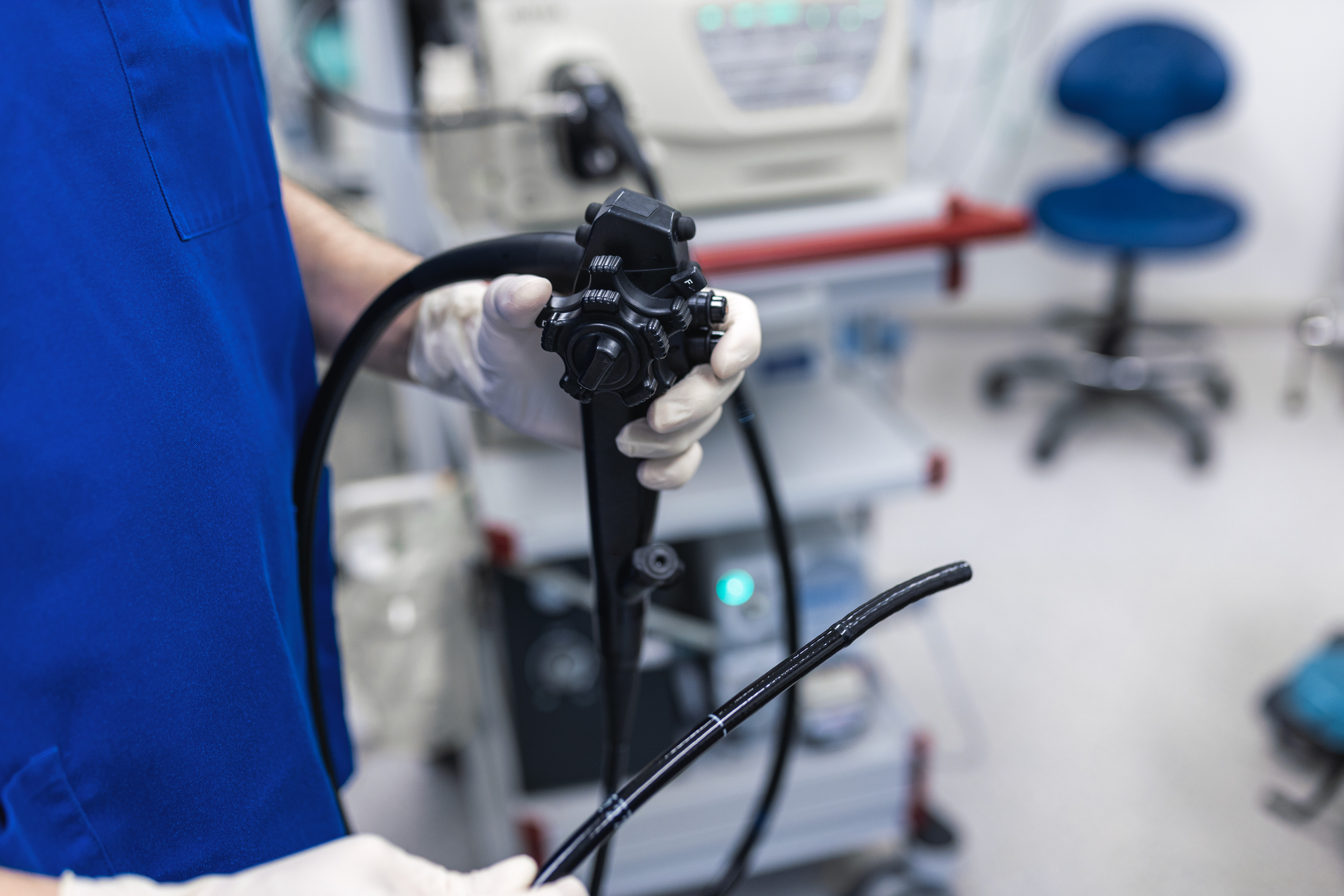 Doctor proctologist holding endoscope during colonoscopy. Probe colonoscope. Doctor gastroenterologist with probe to perform gastroscopy and colonoscopy