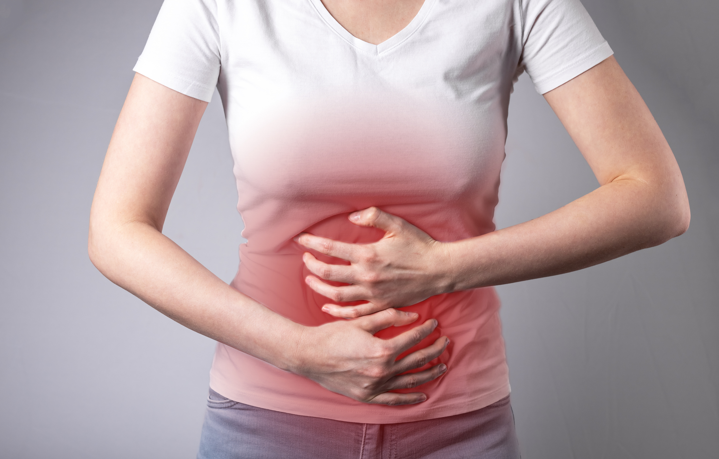 Stomachache. Gastrointestinal diseases. Woman hands on painf